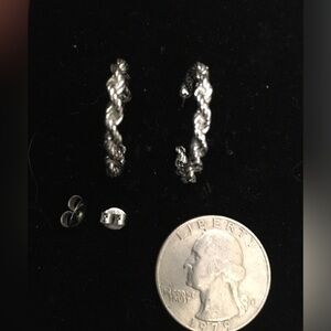 Silver colored hoop earrings.